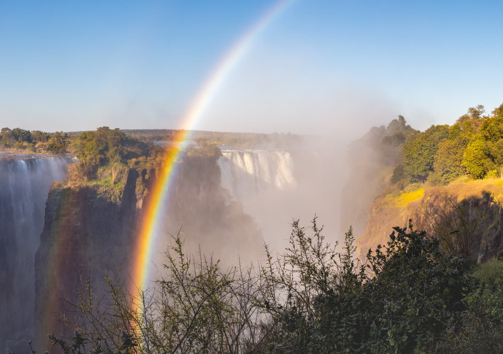 Victoria Falls plunging into the gorge with spray rising above